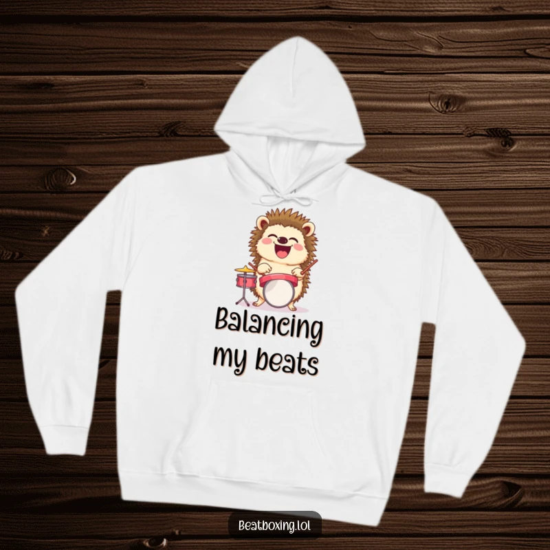 Funny hoodie illustration of a laughing hedgehog balancing a tiny drum set, a perfect funny music gift.